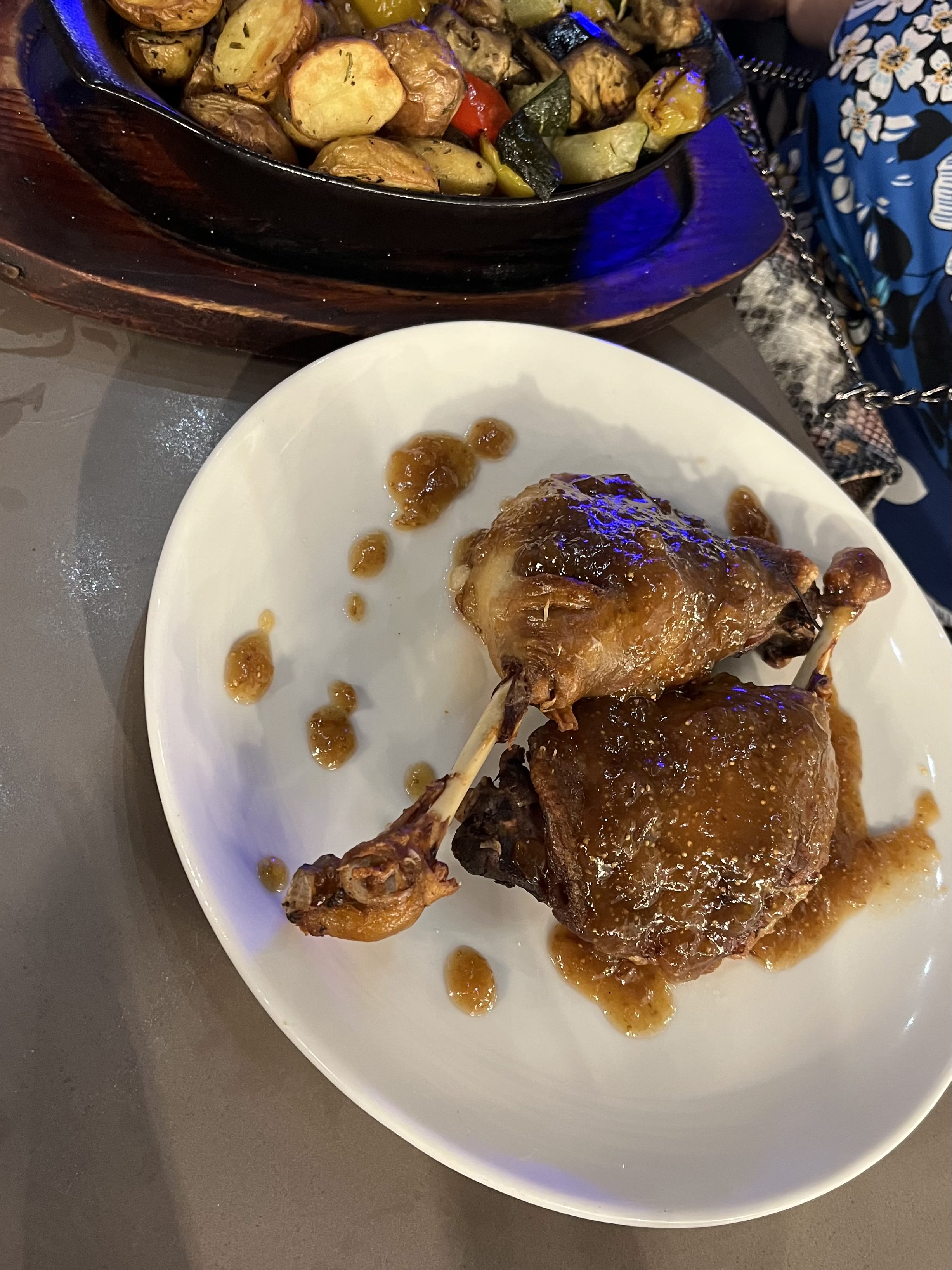 Duck leg confit with fig sauce, roast potatoes and vegetables